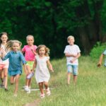Kids, children running on meadow